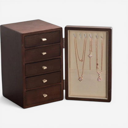 Boîte à bijoux en bois avec espace pour suspendre colliers et tiroirs de rangement.