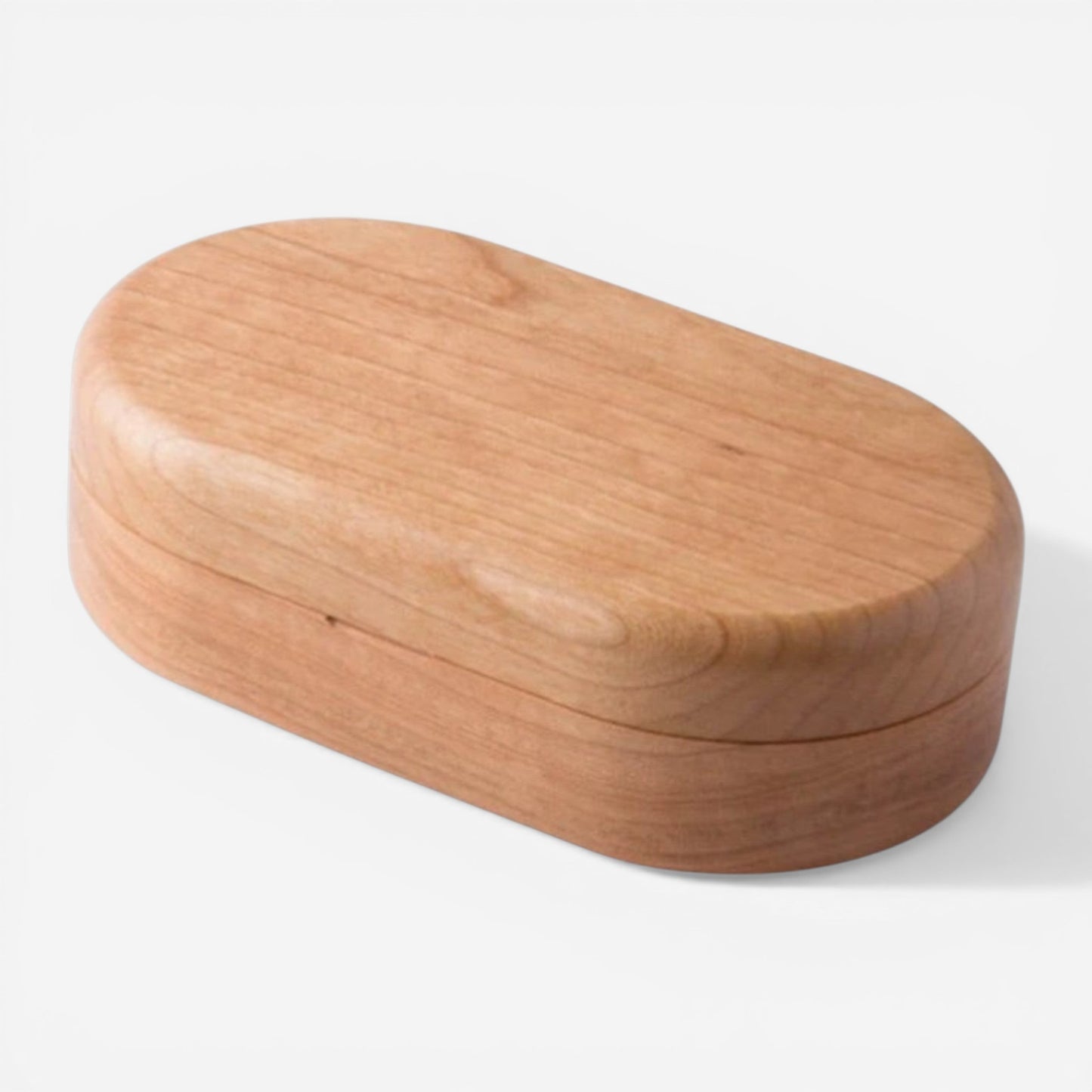 Boîte à bijoux compacte en bois marron clair avec design minimaliste et finition naturelle.
