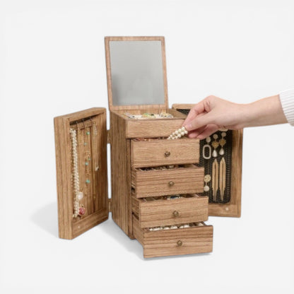 Boîte à bijoux en bois avec tiroirs, miroir intégré et compartiments pour ranger bagues, colliers et accessoires.