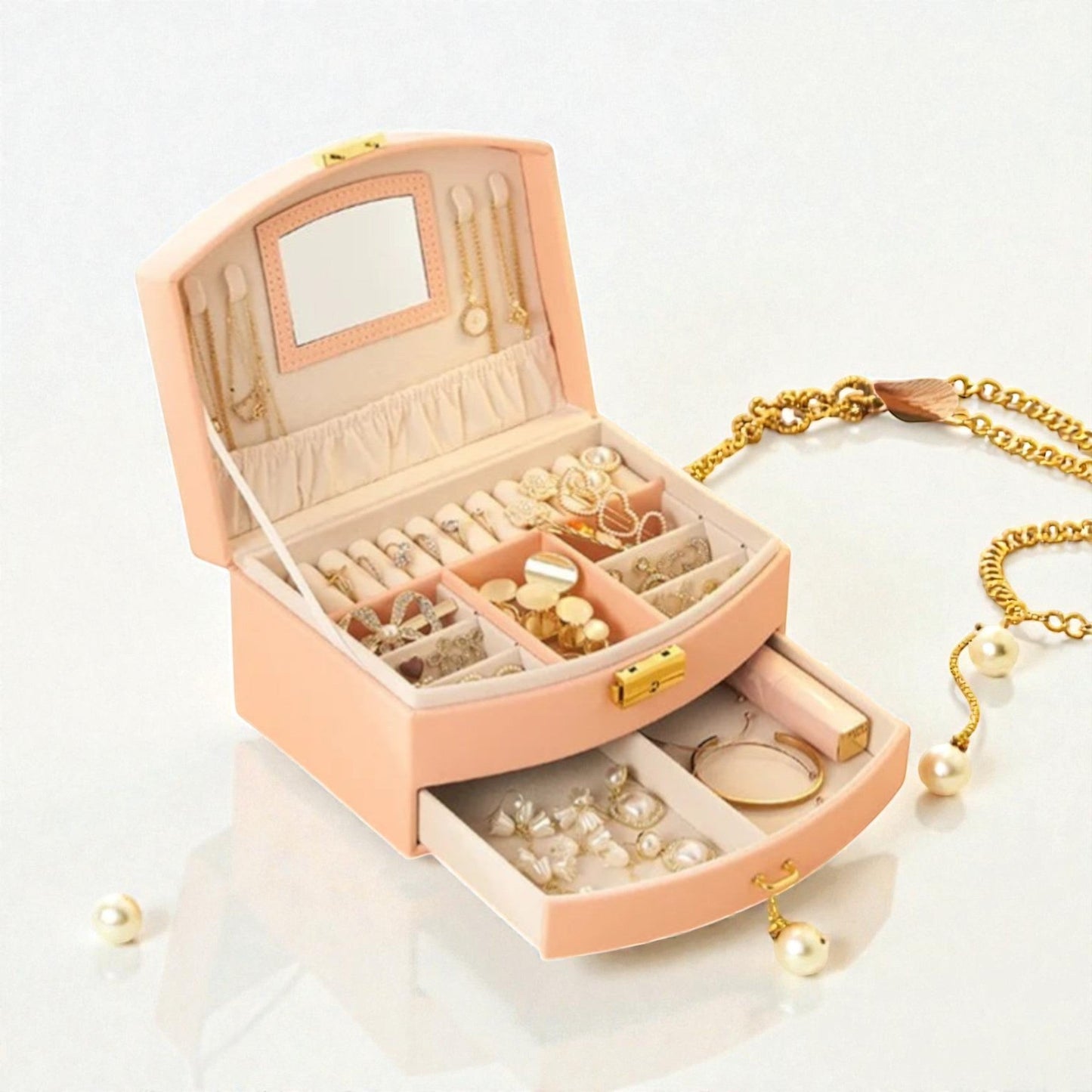 Boîte à bijoux couleur pêche avec tiroir et rangement pour bagues et accessoires.