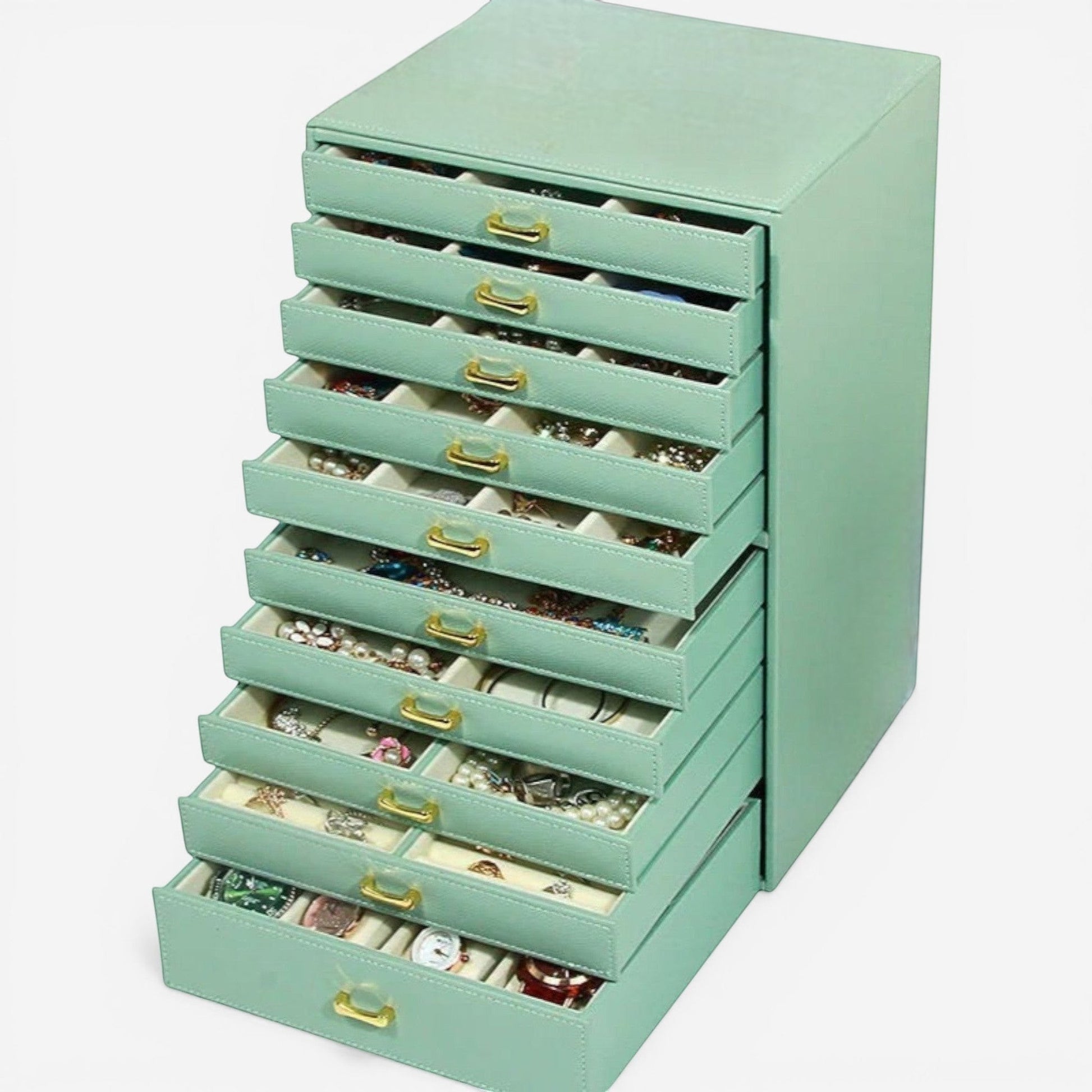 Boîte à bijoux vert clair avec tiroirs multiples pour organiser les bijoux.