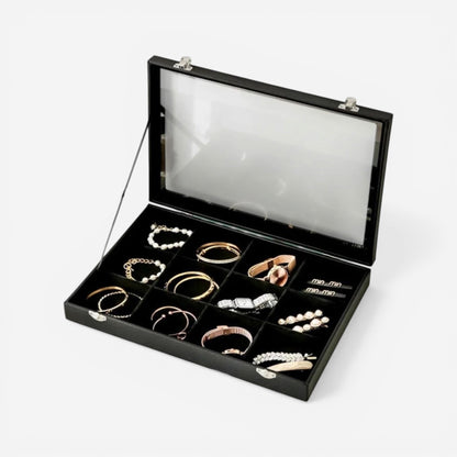 Boîte à bijoux compacte en cuir noir avec vitre transparente, pour un rangement élégant des bijoux.