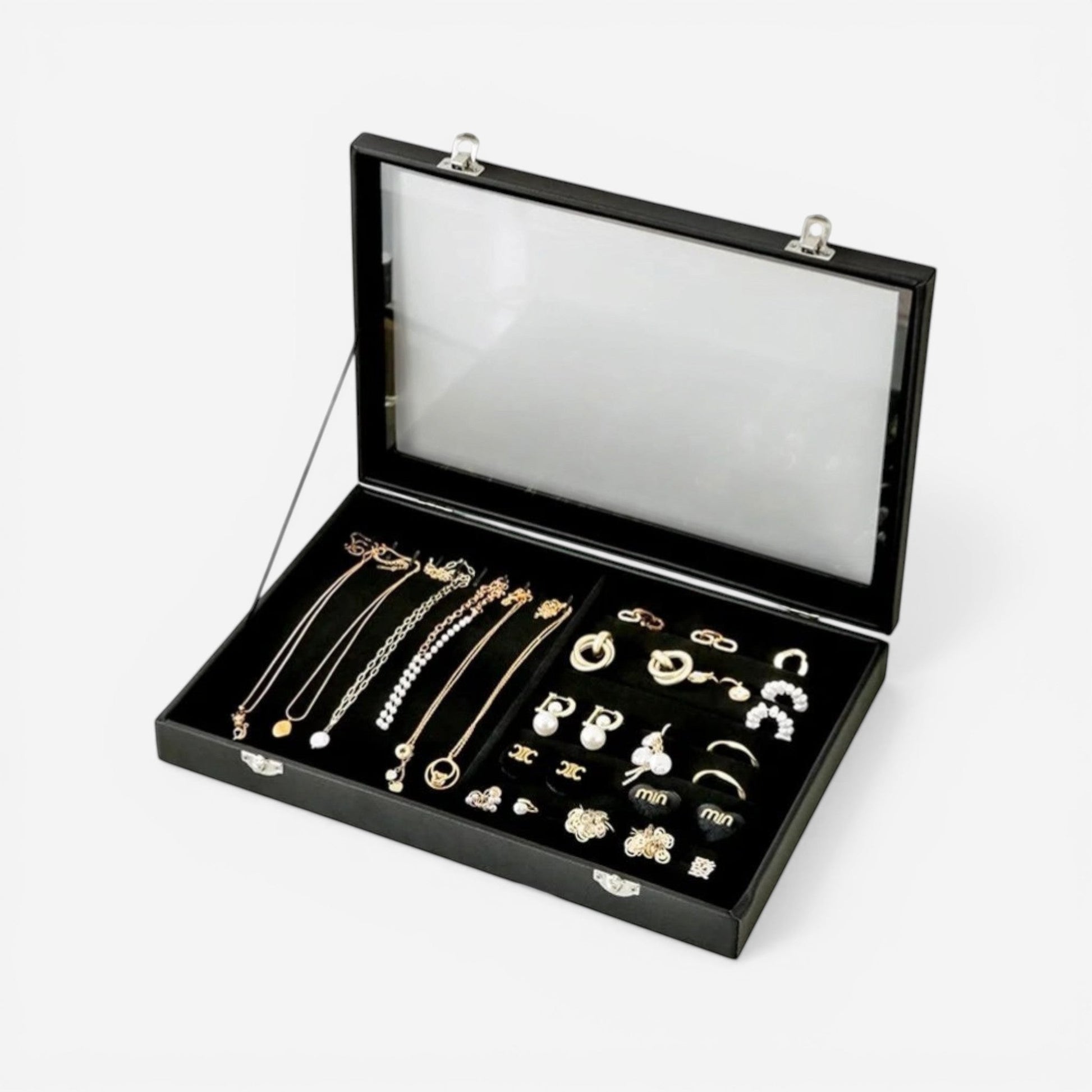 Boîte à bijoux en cuir noir avec vitre transparente, idéale pour organiser bagues et accessoires.
