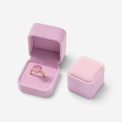 Mini boîte à bijoux SecretGleam en velours rose contenant une bague avec une pierre rose, vue ouverte et fermée